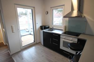 a kitchen with a sink and a stove top oven at NEU! FeWo Großfelden 3 in Goßfelden