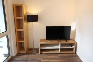 a living room with a television on a table at NEU! FeWo Marburg 2 mit Balkon 