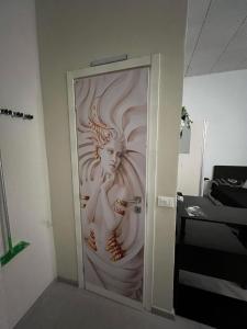 a door with a painting of a woman on it at Stazione centrale La Spezia 5 Terre - Luxury house in La Spezia