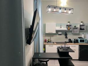 a small kitchen with a black table in a room at Stazione centrale La Spezia 5 Terre - Luxury house in La Spezia