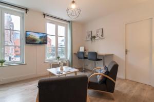 a living room with two chairs and a table at Hypercentre - 2 pièces confortable in Lille +14 photos