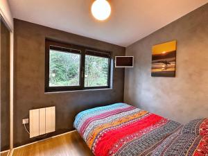 a bedroom with a bed and a window at Chy Cos. South facing lodge with balcony & views. in St. Agnes 
