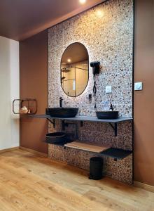 a bathroom with two sinks and a mirror at Tresors de Sens in Sens