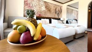 a bowl of fruit on a table in a hotel room at Platinum Hotel and Casino Bansko in Bansko