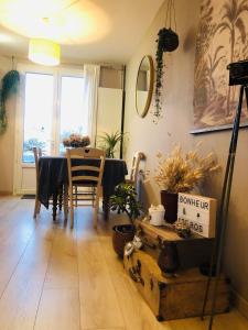 a dining room with a table and chairs and a window at Maison paisible in Niort +3 photos