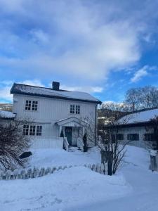 una casa blanca con nieve delante en Fritidsbolig i Flå sentrum en Flå