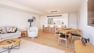 a living room with a couch and a table at Beautiful urban apartment 5 in Nelson