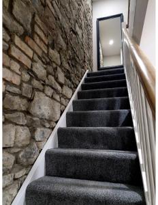 a staircase with a stone wall and a stone stair case at Station Lodge in Sligo
