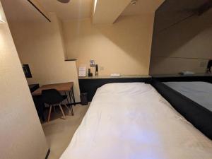 Postel nebo postele na pokoji v ubytování ラグナイン 八王子 Laguna inn + 8 fotografií
