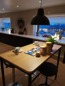 a wooden table in a kitchen under a black light at Andenes Sentrum Apartment in Andenes