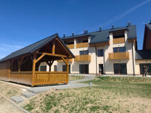 a building with a gazebo in front of it at Apartmán Mavis in Kašperské Hory