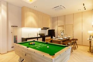a living room with a pool table in it at Nue Hatyai Pool Villa 147 in Songkhla