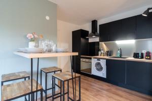 a kitchen with a counter and a washing machine at Lille Grand Place - 1 bedroom apartment in Lille