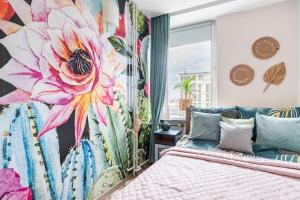 a bedroom with a large flower mural on the wall at Boho Chic City Center in Warsaw