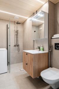 a bathroom with a sink and a toilet and a shower at 2ndhomes Tampere "Pyynikki" Top Floor Loft Apartment in Tampere