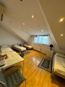 a attic room with three beds and a desk at ESA Home in Warsaw