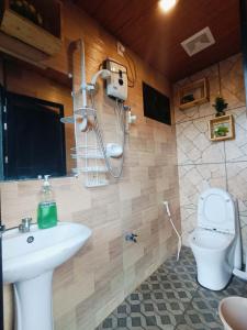 a bathroom with a sink and a toilet at Holyghost Veranda Baguio Transient Guest House 42 step rooftop in Baguio