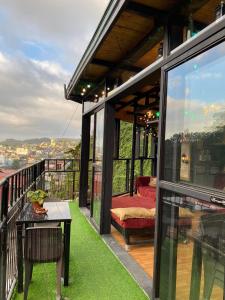 a balcony of a house with a view of the city at Holyghost Veranda Baguio Transient Guest House 42 step rooftop in Baguio