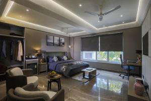 a living room with a bed and a couch at KRYC Luxury Living in New Delhi