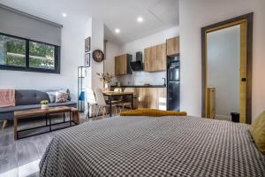 a bedroom with a bed and a living room at Garesc Lofts in Córdoba