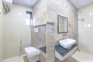 a bathroom with a toilet and a sink and a mirror at FabExpress Grand Inn I in Lucknow