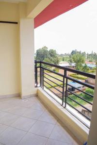 a balcony of a building with a view of theenery at Marvel Homes in Meru