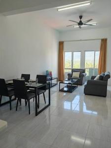 a living room with a dining table and chairs at Langkawi Homestay Family Suite 3Bed Room in Kuah