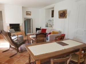 ein Wohnzimmer mit einem Tisch und Stühlen in der Unterkunft Le Clos- Le Pavillon in Lombard