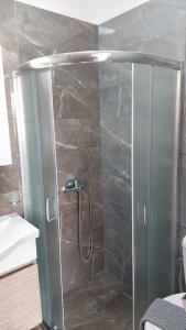 a shower with a glass door in a bathroom at Sea La Vie Beach House in Petra