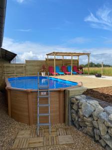 a hot tub with a ladder on top of it at Gite Charbonnaud in Laprade