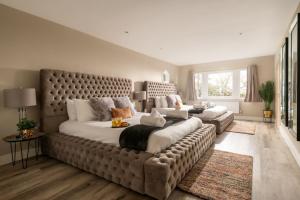 a large bedroom with a large bed with a large couch at Sunset Cottage in Sandwich