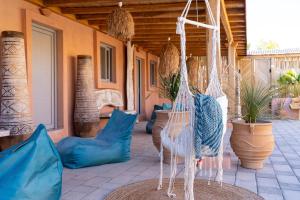 a porch with blue pillows and a swing at Onar Villa Kolympia in Kolimbia