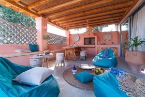 a living room with blue couches and a table at Onar Villa Kolympia in Kolymbia