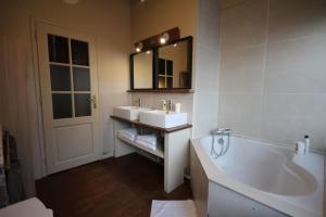 a bathroom with two sinks and a tub and a mirror at Old Town - Lovely typical house in Lille