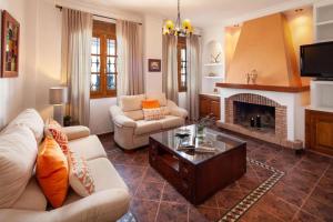 a living room with a couch and a fireplace at TESS Casa La Alcazaba de Serrato in Serrato