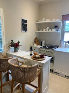 a kitchen with a table with a plate of food on it at The Alphen Cottage in Cape Town