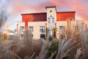 a house in the middle of a field of grass at Hotel APARTmenthouse in Rülzheim