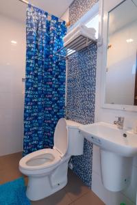 a bathroom with a toilet and a sink at Bay Area Lodge in Coron