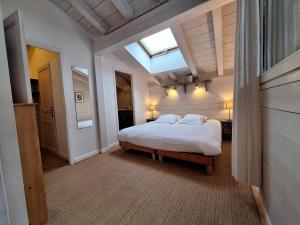 a bedroom with a large bed with a skylight at Le Chalet des Grands Montets 2 in Chamonix