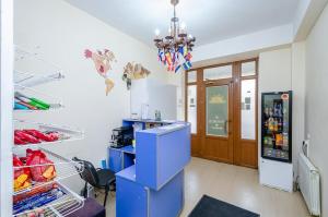 a kitchen with a blue refrigerator and a chandelier at Areva Hostel & Apartment in Yerevan