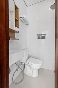 a white bathroom with a toilet and a sink at Asasta Villa by Betterplace in Tabanan +13 photos