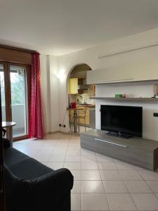 a living room with a flat screen tv and a couch at PM 2 Via De Gasperi Guest House in Rozzano