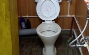 a bathroom with a toilet with the lid up at The Leo Homestay Cottage by StayApart , Buxa in Jayanti