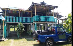 a blue jeep parked in front of a house at The Leo Homestay Cottage by StayApart , Buxa in Jayanti