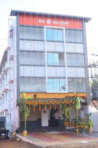 a building with a banner in front of it at Shiva Deluxe Lodge in Shimoga