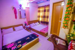 a small bedroom with a bed and a window at Hotel Victoria Inn (Nazimuddin Road) in Dhaka