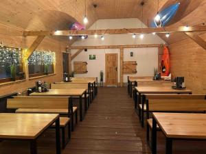 a dining room with wooden tables and chairs at Pokoje nad Przełomem Dunajca - Wietrznice - Rivent Sport in Łącko +19 photos