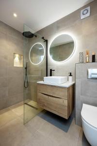 a bathroom with a sink and a glass shower at Veeve - The Peace Lily in London