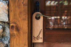 a wooden door with a spoon and a handle at Ratxó Retreat Hotel, member of Meliá Collection in Puigpunyent