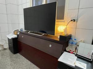 鹿港的住宿－鹿港宏旭民宿，房间里的梳妆台上方的电视机